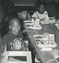 Small children enjoy lunch at Pastor Paul's Mission Hot Meals Program.